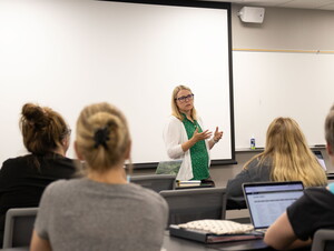 Social Work Program Director Toni Jensen in the front of a classroom teaching.