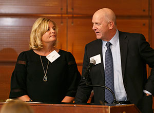 Julie and Kevin at a podium