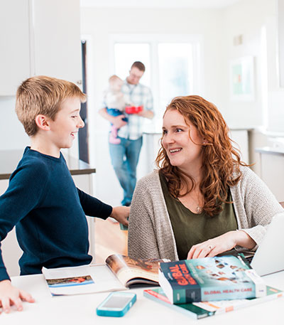 Nursing student studies at home with her family.