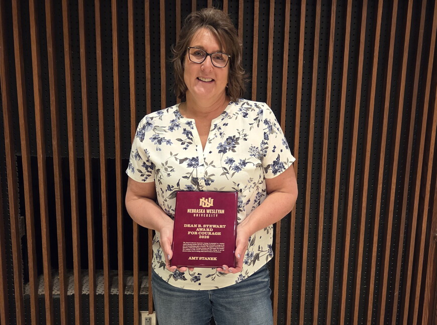 Amy Stanek holding her Stewart Award.