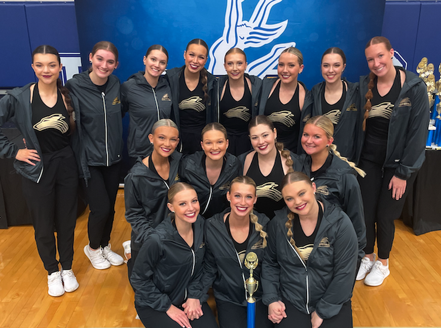 NWU Gold Rush dance team at the UDA Spirit of the Midwest Challenge with their first-place trophy. 
