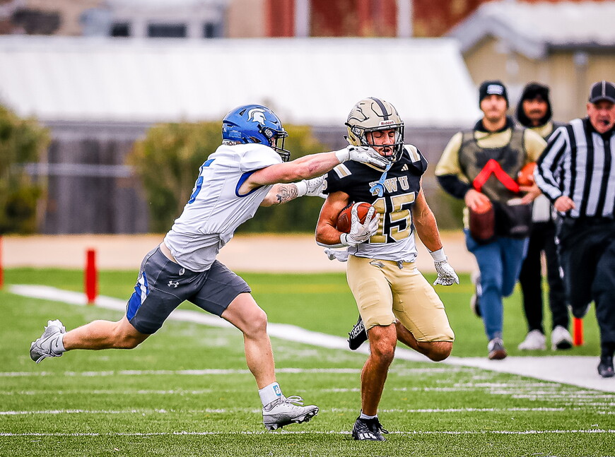 Ghaith Taha carries the ball during a NWU football game.