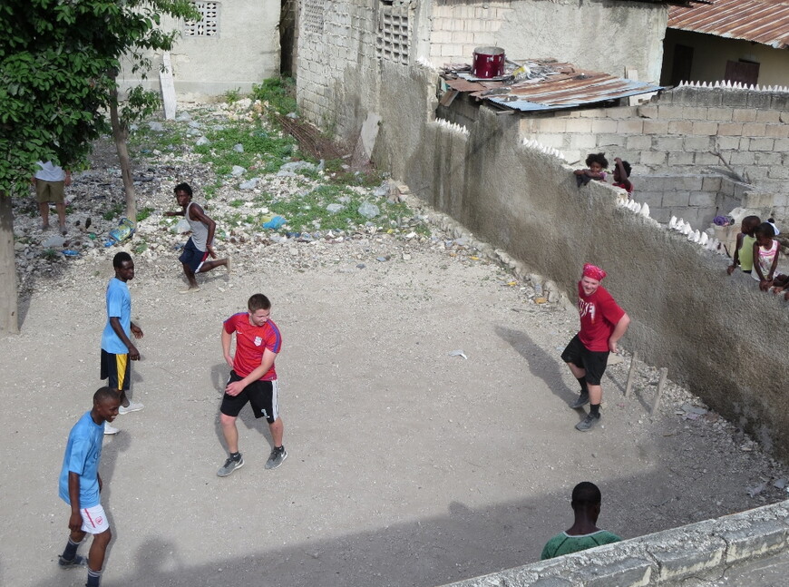 NWU students play games with Haitian students during an educational exchange to the country.