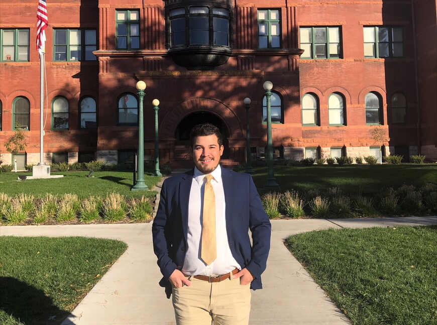 Alexis Ortega '22 in business attire in front of Old Main