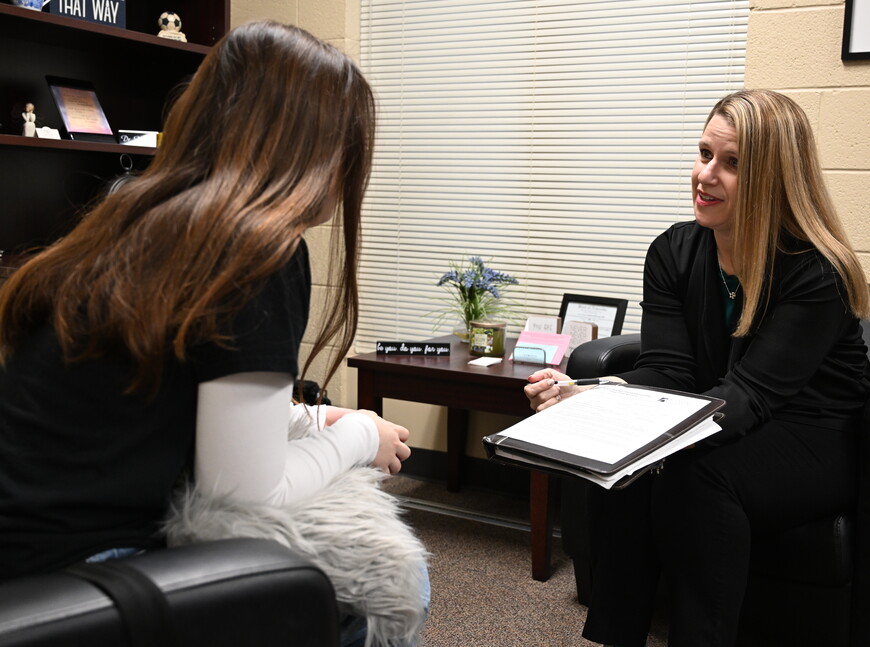 Kim Corner talking to a student
