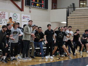 NWU wrestlers cheer on a teammate.