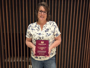 Amy Stanek holding her Stewart Award.
