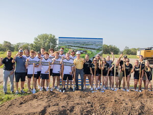 NWU baseball and softball players and coaches surround President Good at sports complex ground breaking.