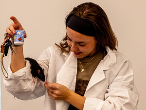 A student rewards her rat during the 2025 Xtreme Rat Challenge.
