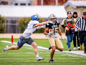 Ghaith Taha carries the ball during a NWU football game.