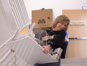 Psychology department staff move boxes down the new stairwells of Acklie Hall of Science. 