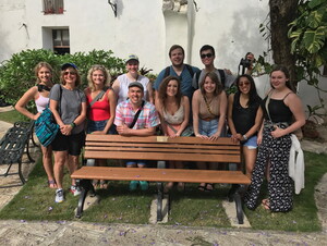 Students gather around a bench that was donated by former First Lady Michelle Obama during her visit to Cuba in 2015.