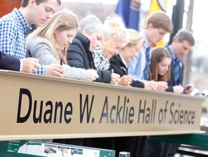 Members of the Acklie family are the first to sign a beam to the Duane W. Acklie Hall of Science.