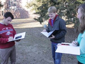 Students chart their findings after locating a squirrel.