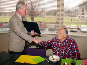 President Fred Ohles congratulates David Mickey