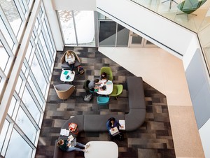 From a third floor view looking down on students studying in the entrance of Acklie Hall of Science.