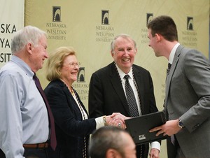 Reba and Harry Huge (center) congratulate a Huge scholarship winner at last year's inductee ceremony.
