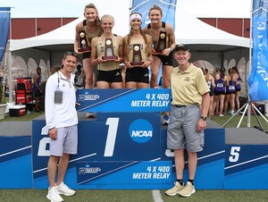 NWU's women 4x400 relay team on the top podium of winners flanked by their coaches.