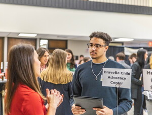 Student talking to faculty member
