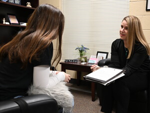 Kim Corner talking to a student