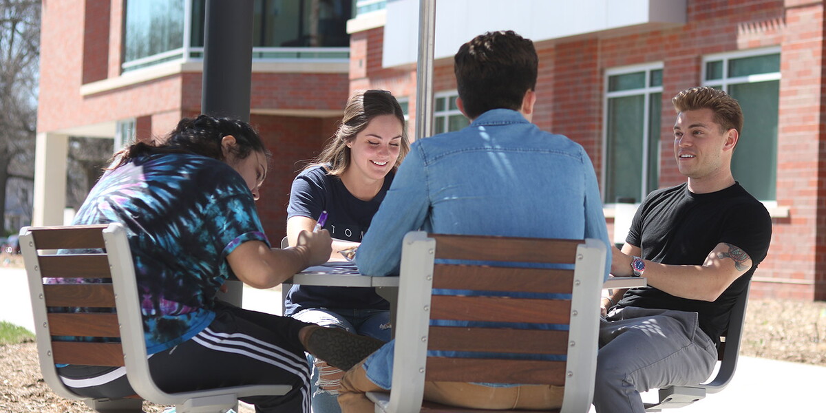Four students outside studying together