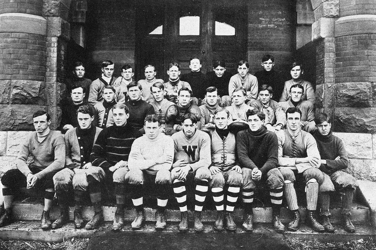 Dated 1908, this is an old photo of several young men are sitting on the steps of Old Main