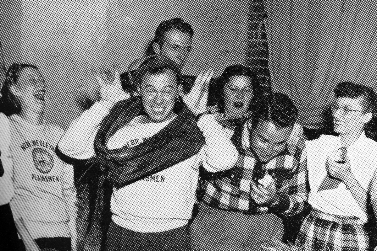 Students from 1940 laughing and acting silly in this old yearbook photo.