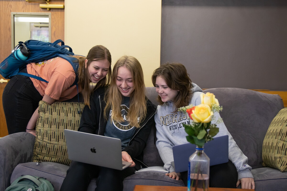 Students gathereed around a computer