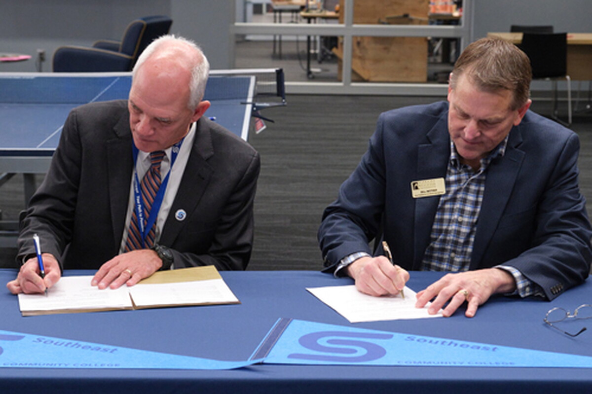 Dr. Paul Illich, SCC president, and Bill Motzer, vice president for enrollment management at NWU, sign the Biotechnology Pathway Agreement.