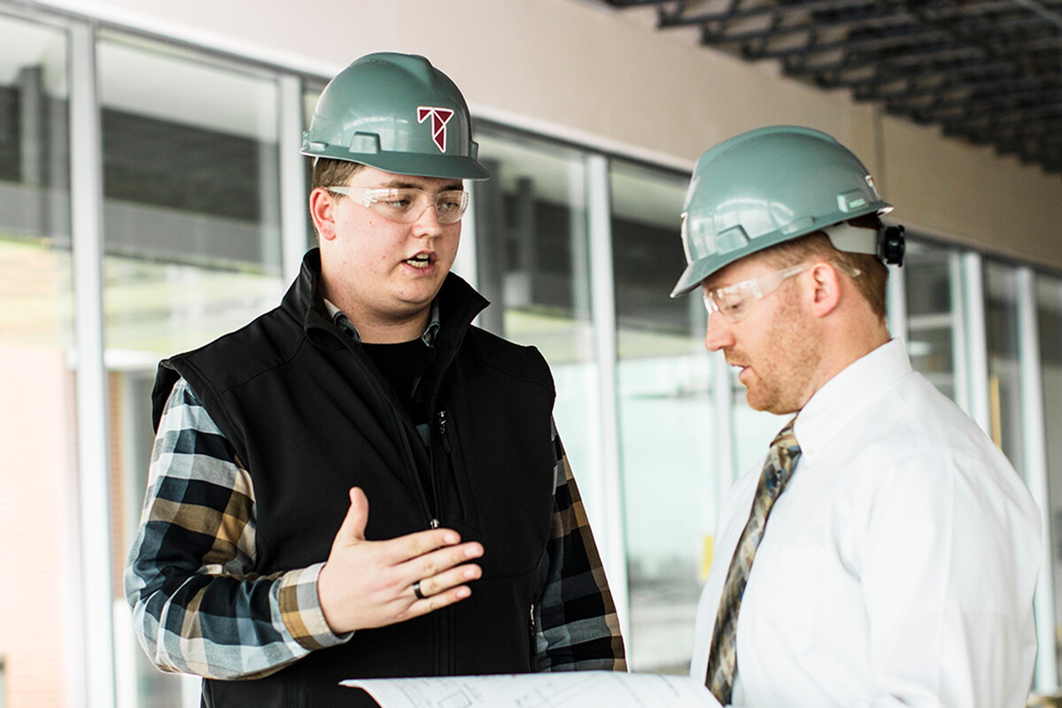 Ty Garner at a Tetrad construction site talking to the job forman.