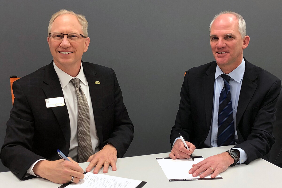 NWU President Darrin Good sitting next to SCC President Paul Illich signing paperwork.