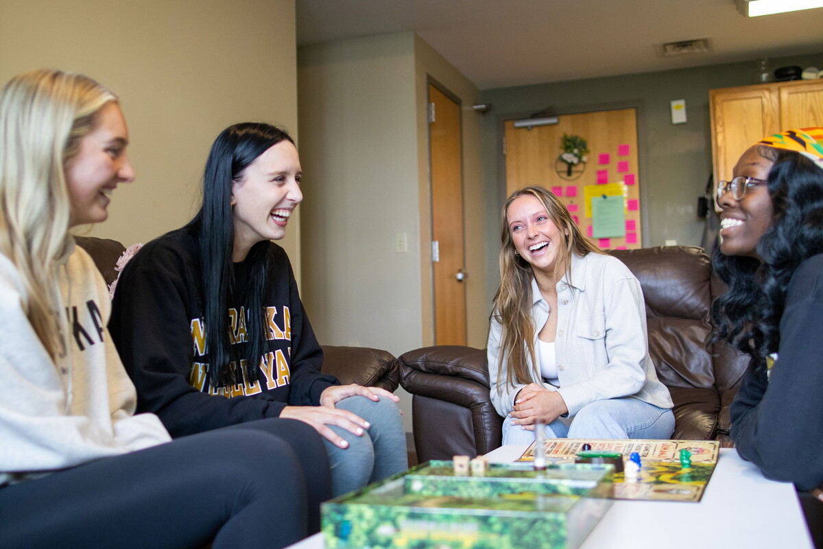 Young women playing a game in a suite.