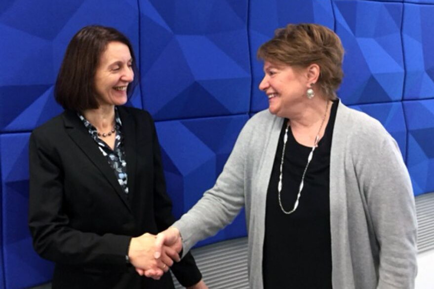 NWU Provost Graciella LivCaneiro-Livingston shakes the hand of Sue Raftery, associate vice president of academic affairs at Metropolitan Community College