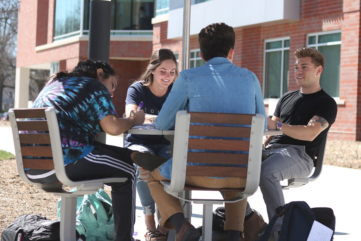 Four students outside studying together