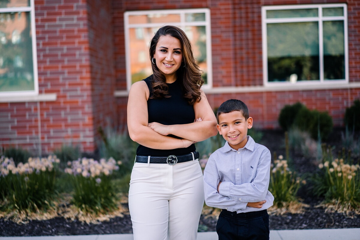 Rae Sallae and her son standing in front of Acklie Hall.