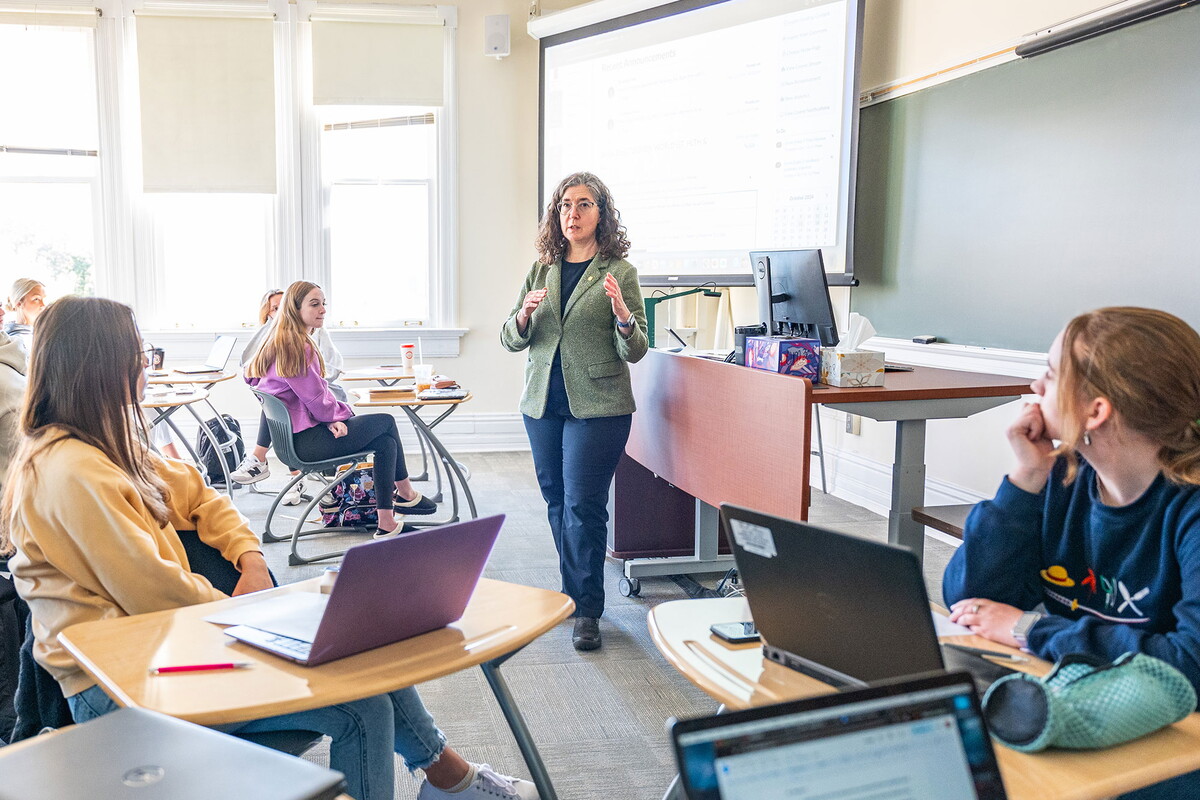 Sarah Kelen teaching in a classroom full of students.