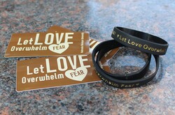 Picture of "Let Love Overwhelm Fear" bracelets and stickers