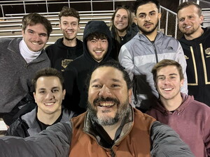 Coach Brandon Bonilla and NWU players in stands