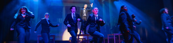 Theatre students on stage dancing.