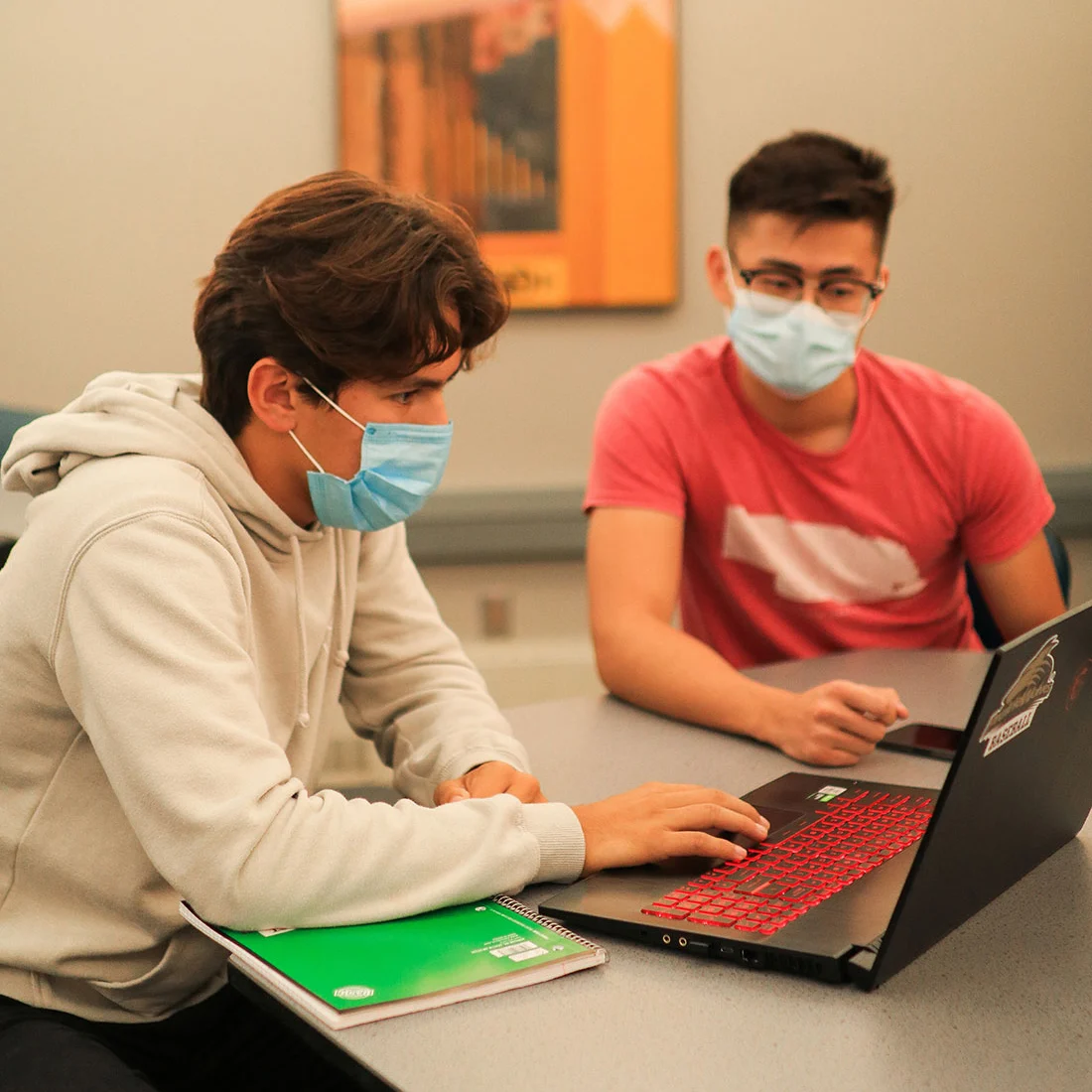 Two male students at collaborating at a table in the Cooper Center
