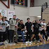 NWU wrestlers cheer on a teammate.