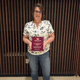 Amy Stanek holding her Stewart Award.