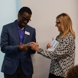 Connie Duncan presents representatives of the Good Neighbor Community Center with a $10,000 check.