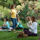 Dr. Jensen leads students in a contemplative moment with a singing bowl outside on campus.